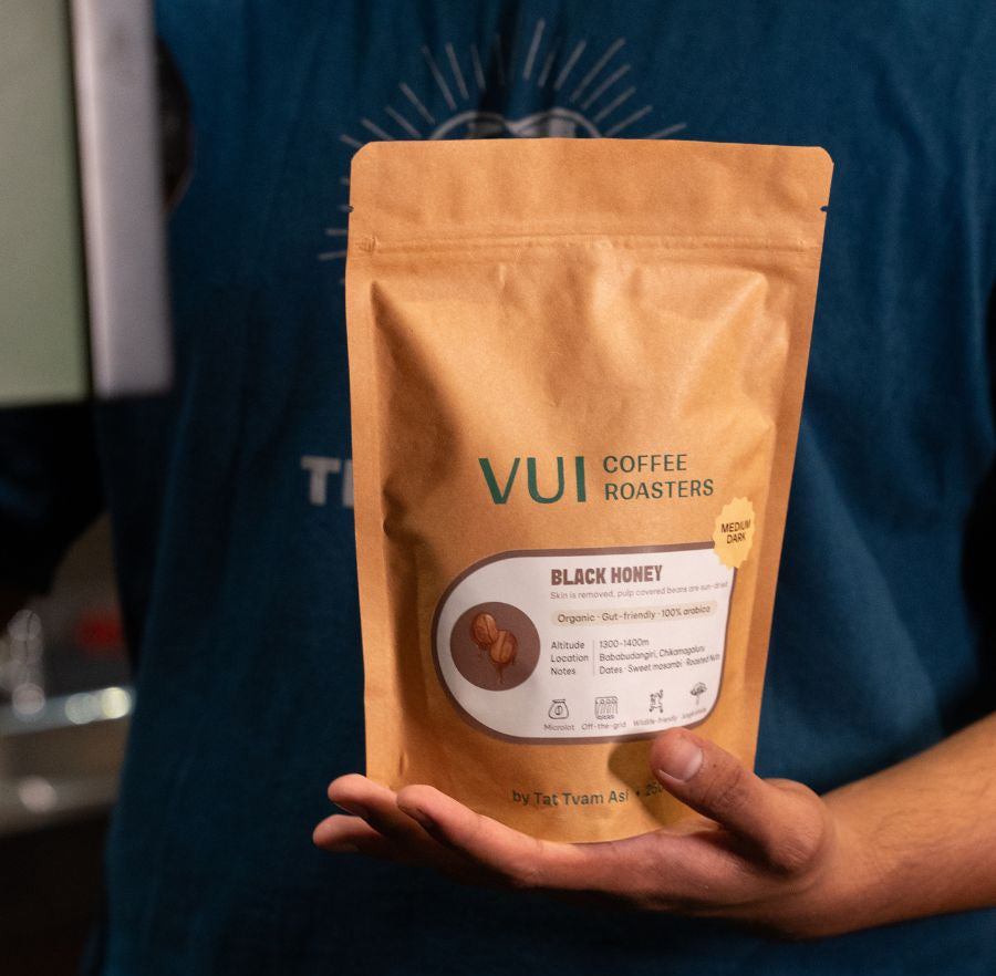 Person holding a VUI Coffee Roasters package of Black Honey coffee
